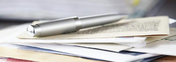 Pen on pile of paperwork