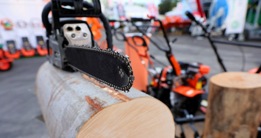 Close-up of woodcutter sawing chain saw blade. Hard wood working