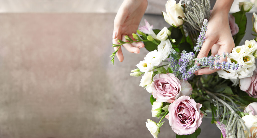 Female florist making beautiful bouquet at flower shop